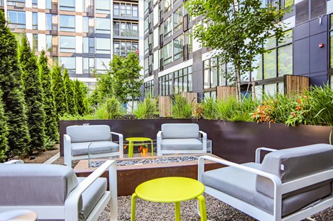 a seating area with chairs and a fire pit
