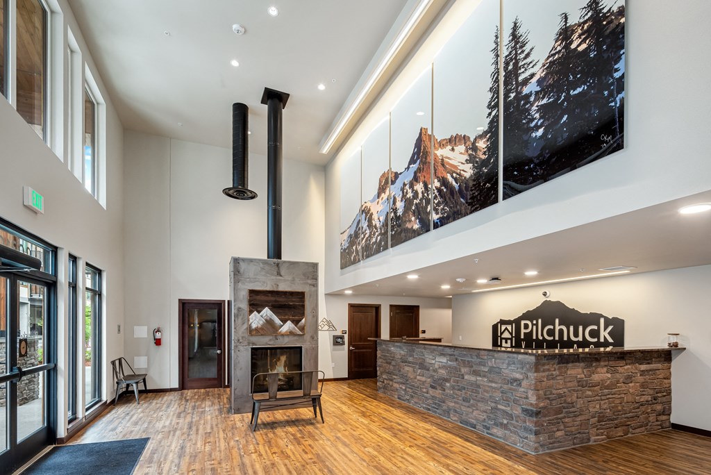 a large lobby with a fireplace and a large painting on the wall