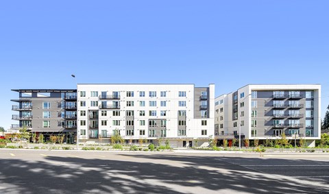 A modern apartment building with a clear blue sky above.