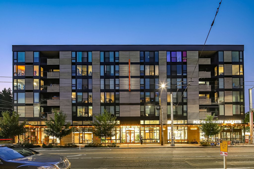 an evening view of an office building on a city street