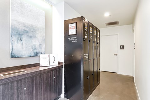a lobby with refrigerators and a counter and a painting on the wall