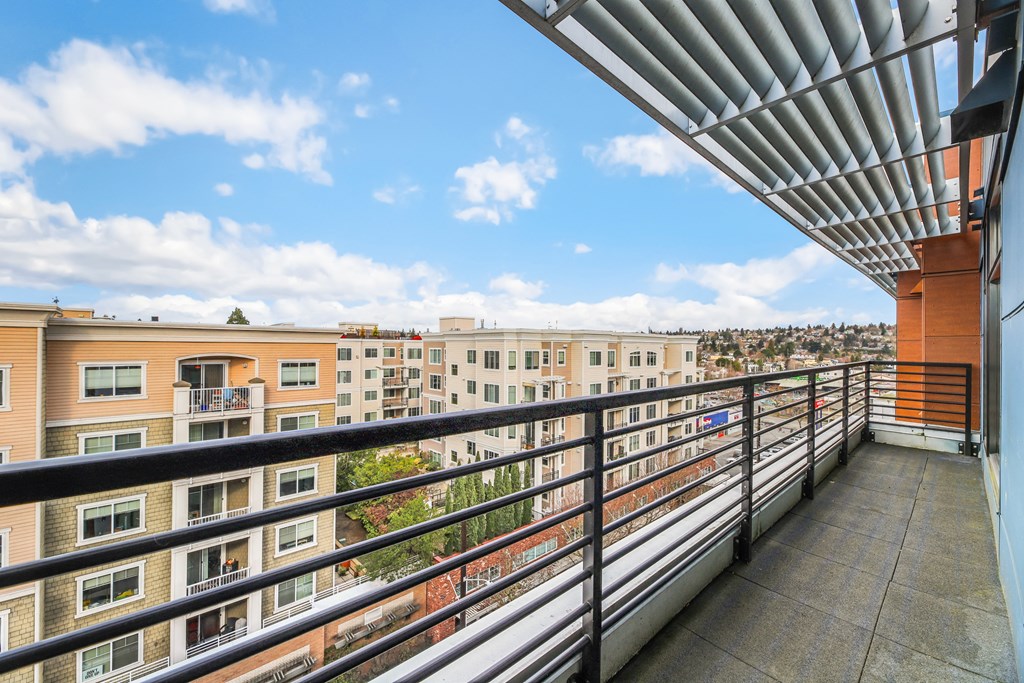 the view of the city from the balcony of an apartment building