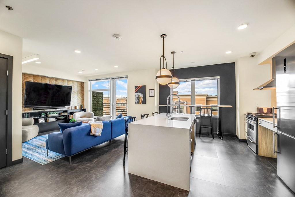a living room with a kitchen and a couch and a table