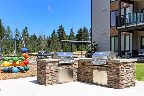 two barbecue grills on the side of a building