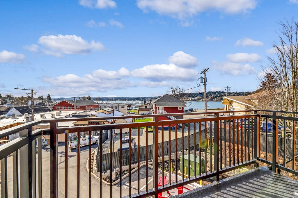 a balcony with a view of a city and a body of water