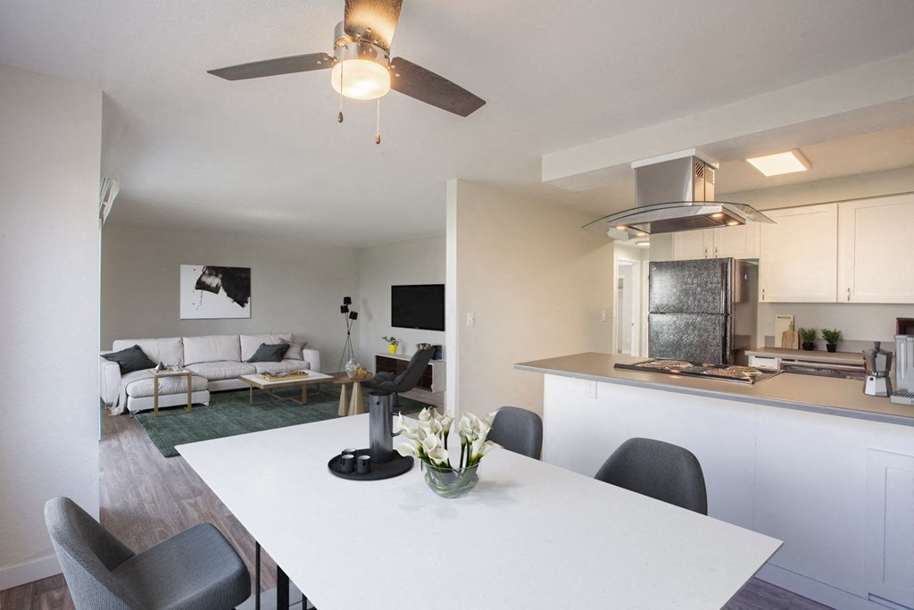 a kitchen and living room with a white table