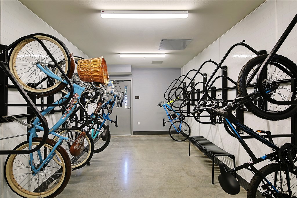 a row of bikes hanging on a wall in a building