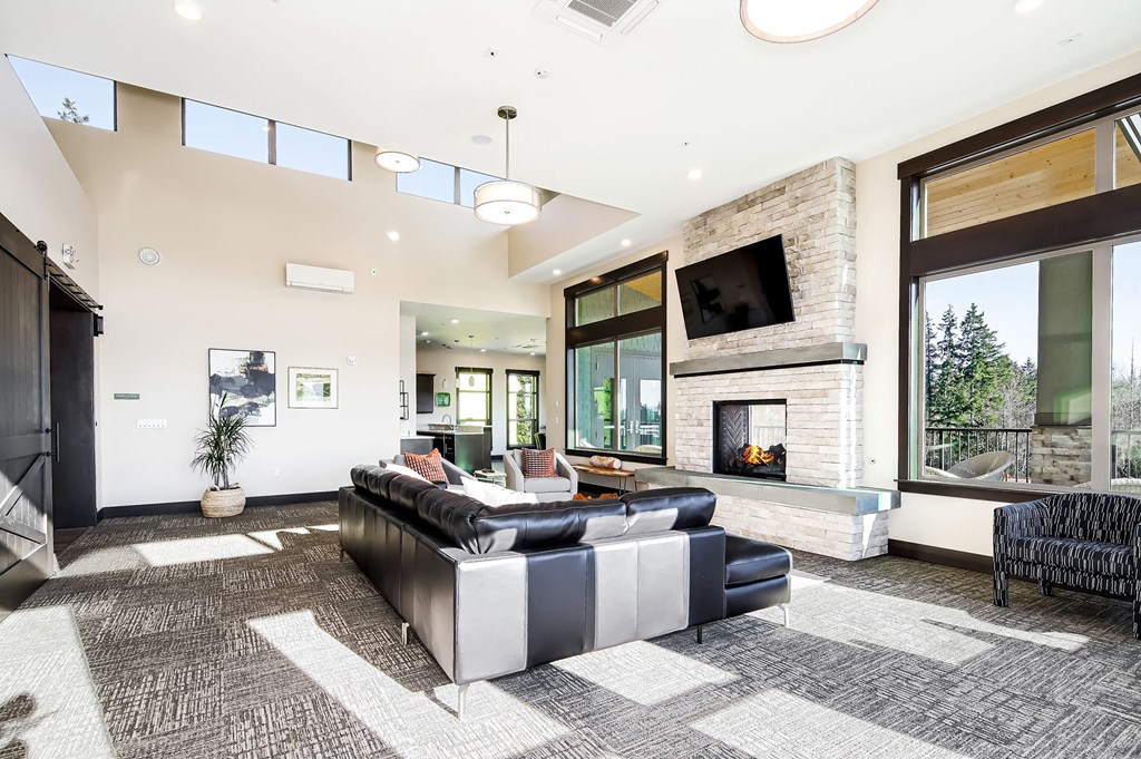 a living room with a leather couch and a fireplace