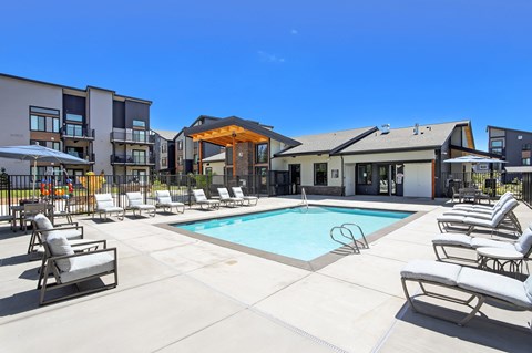 our apartments offer a swimming pool with lounge chairs and umbrellas