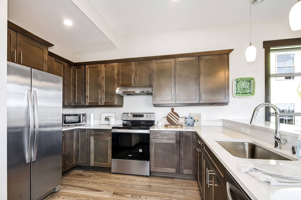 a kitchen with stainless steel appliances and wooden cabinets
