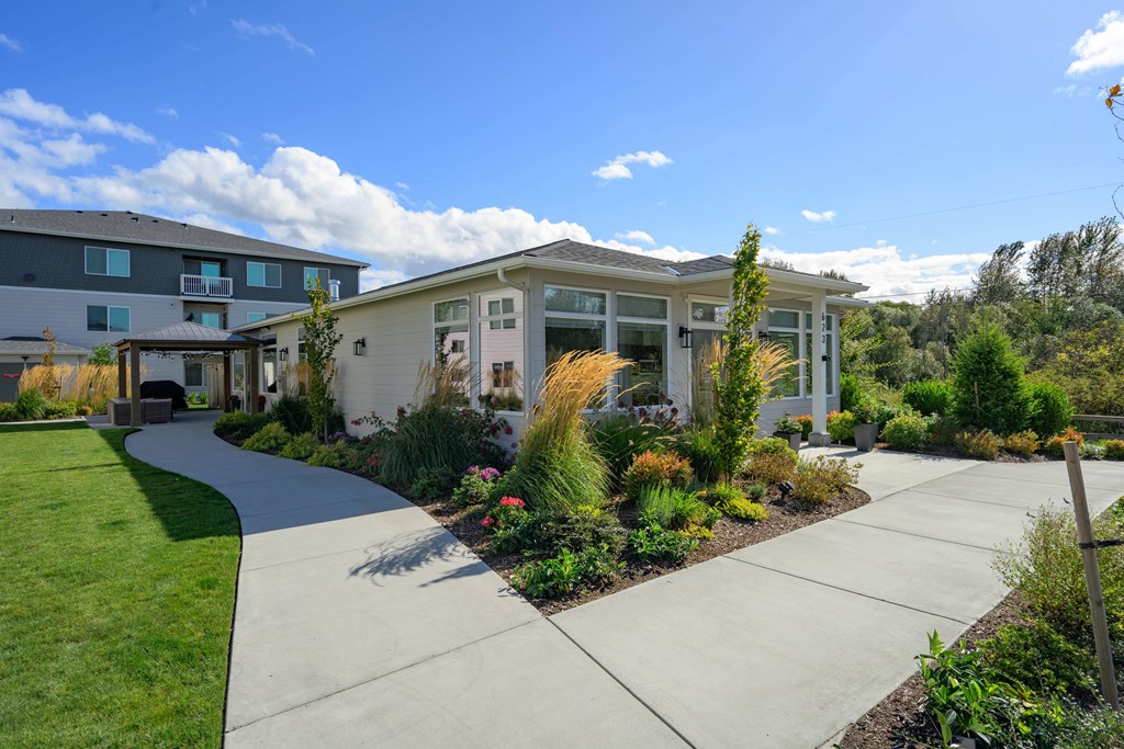 A residential area with a house, a lawn, and a walkway.
