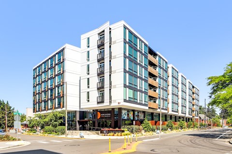 a large white building with a street in front of it