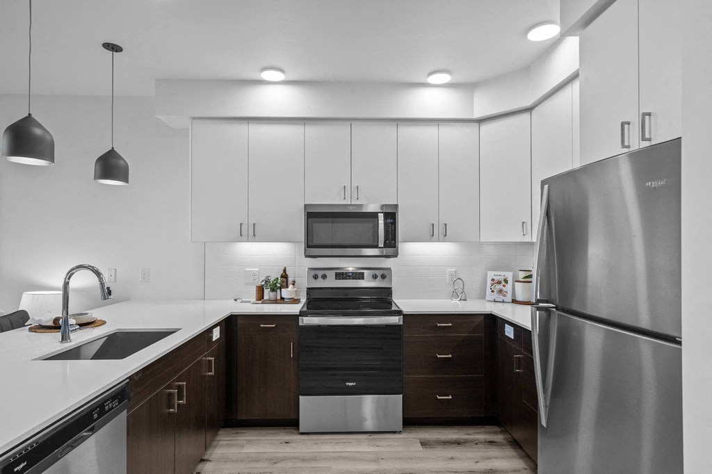 a kitchen with stainless steel appliances and white cabinets