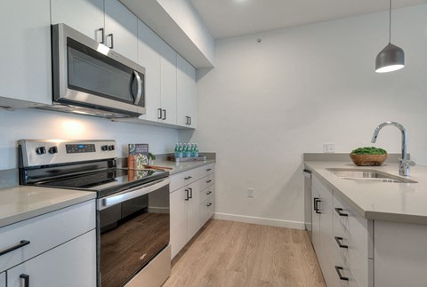 a kitchen with stainless steel appliances and white cabinets