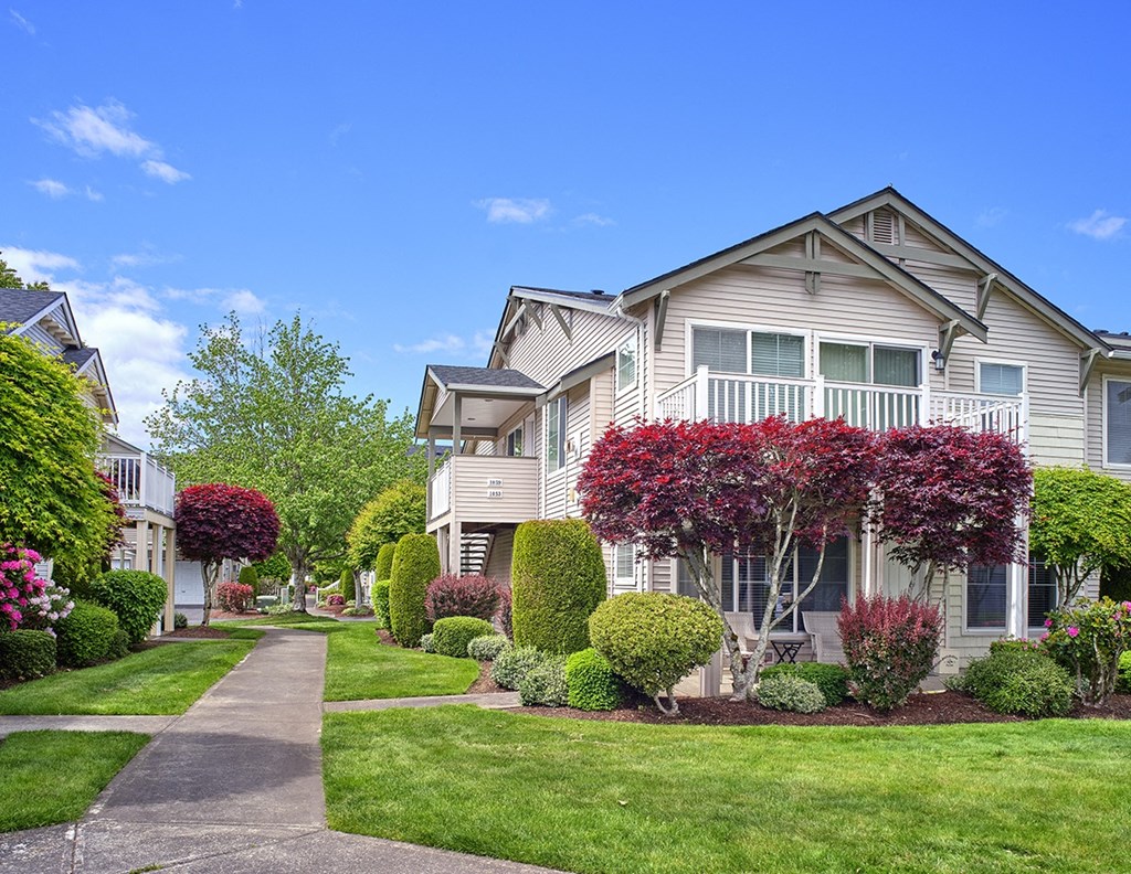 community exterior with lush landscaping and side walks at Clock Tower Village, DuPont