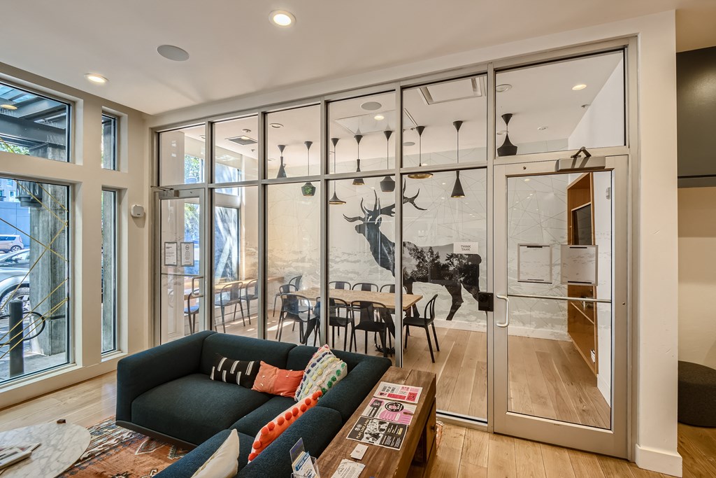 a wall of glass separates the kitchen from the living room