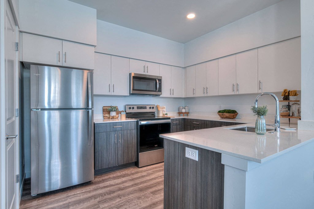 a kitchen with stainless steel appliances and white cabinets