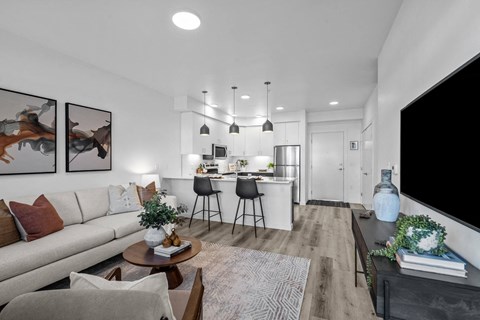 an open living room and kitchen with a couch and a table