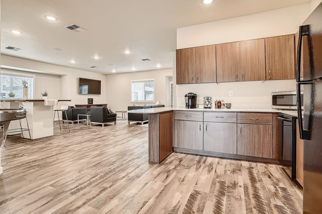 a kitchen and living room with wood flooring