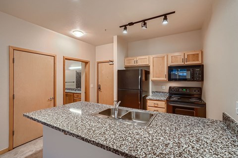 a kitchen with a granite counter top and a sink