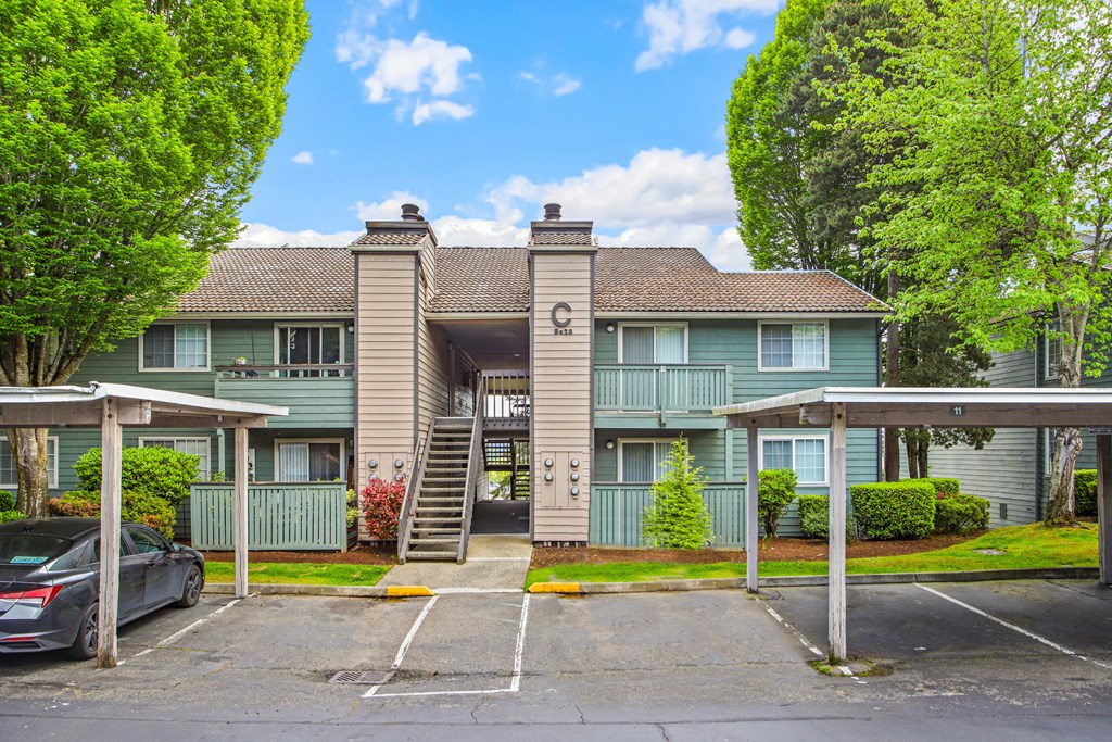 an apartment building with a parking lot and stairs