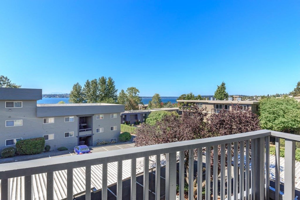 the view from the deck of a condo building overlooking the water
