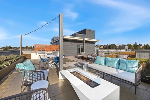 A patio with a white table and chairs with blue cushions.