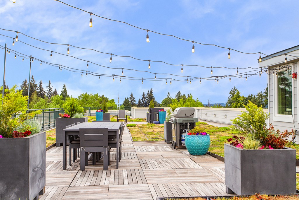 a backyard patio with tables and chairs and string lights