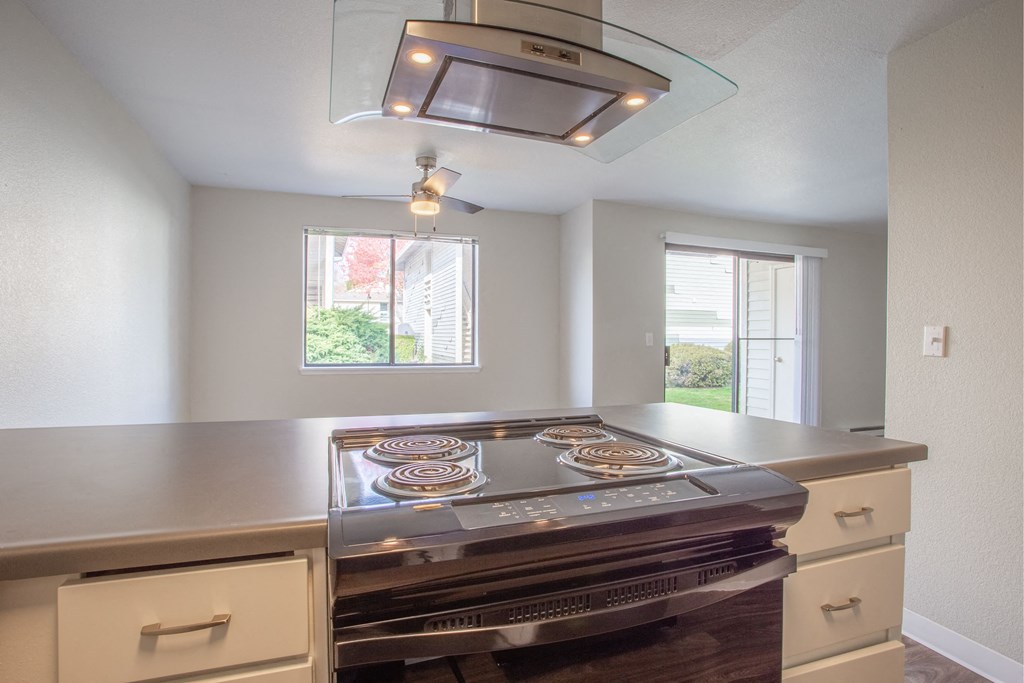 a kitchen with a large island with pizzas on it