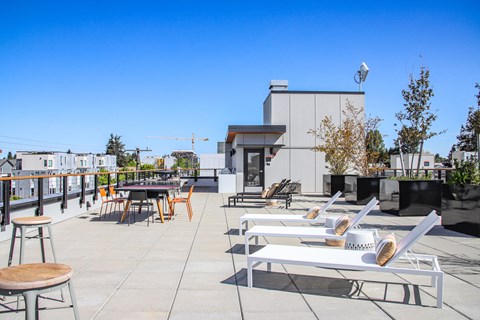 the terrace of the ace hotel has tables and chairs