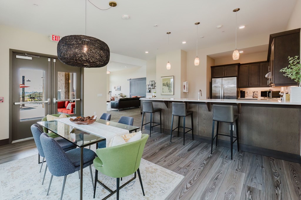 A modern kitchen with a dining table and chairs.