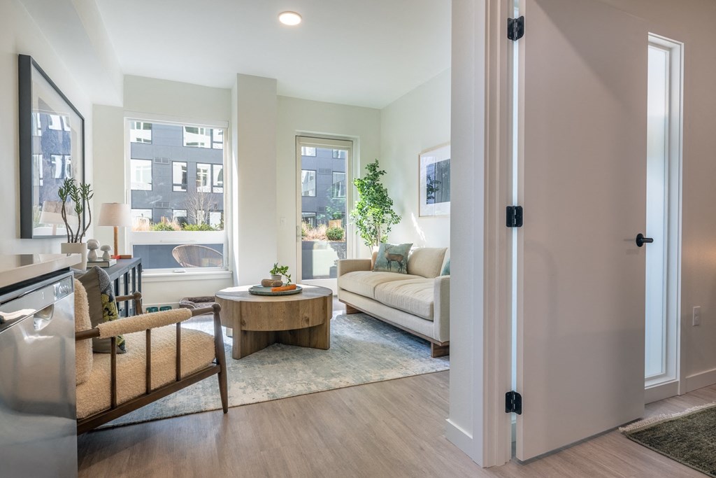 A modern living room with a wooden coffee table and a white sofa.