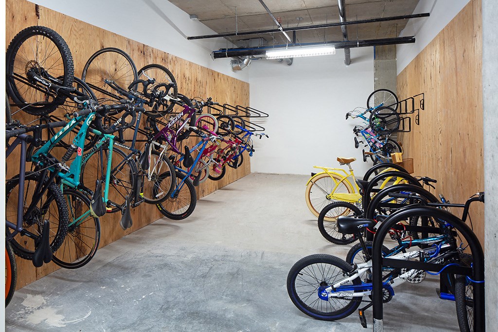 a large storage area with bikes on the wall and on the racks