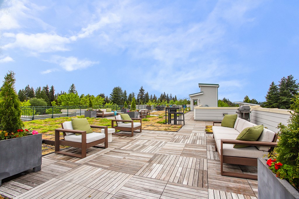 a patio with chairs and tables on a deck