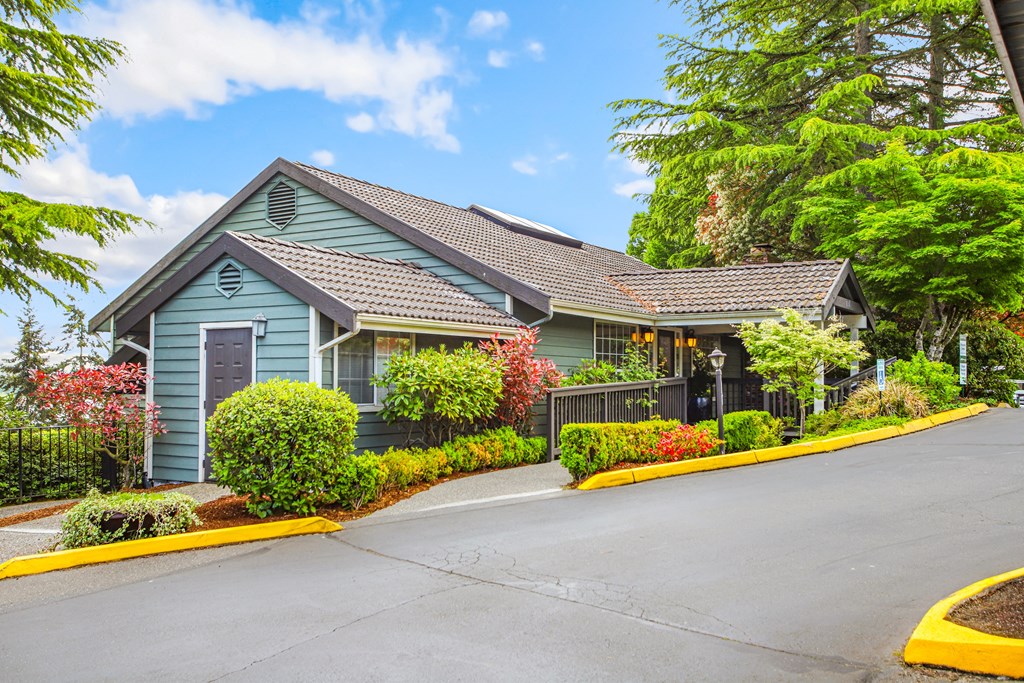 a blue house with a street in front of it