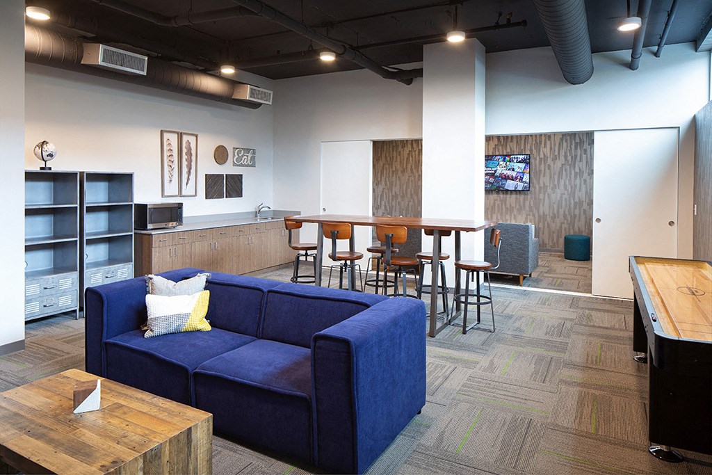 a room with a blue couch and a table with chairs