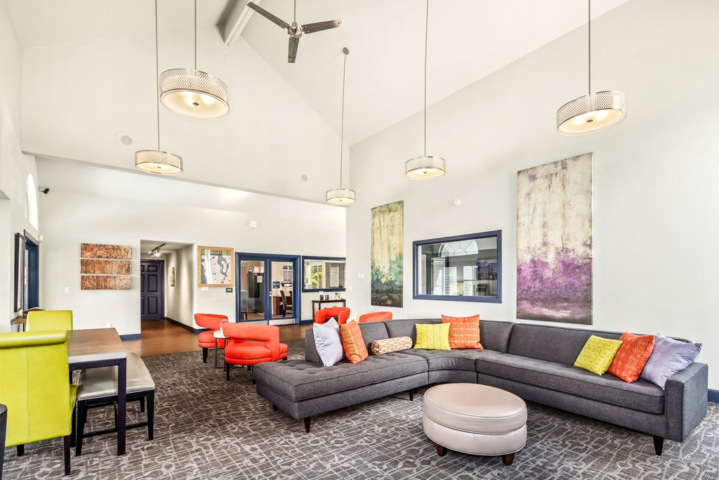 a living room with a gray couch and colorful pillows