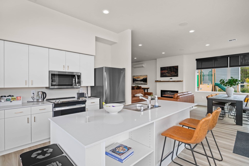 A modern kitchen with white cabinets and a large island.
