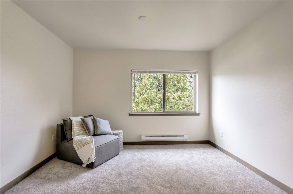 a living room with a couch and a window