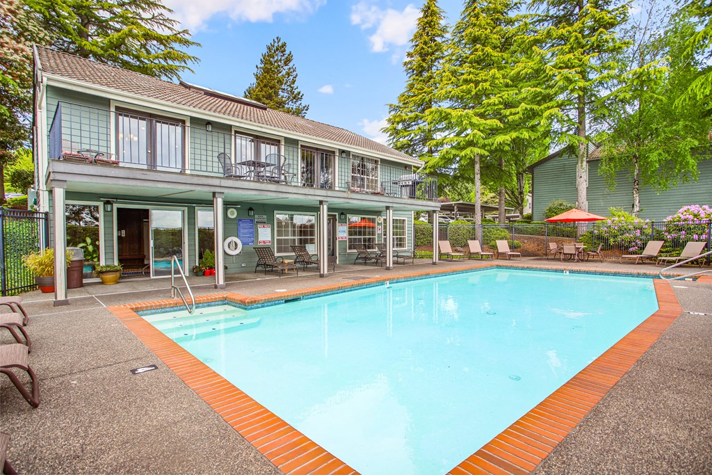 a swimming pool with a house in the background