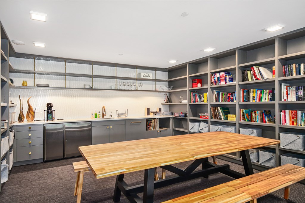 a dining room with a wooden table and bookshelves