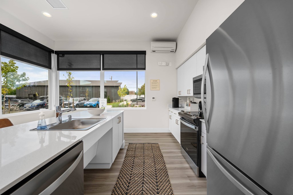 A modern kitchen with a large island and stainless steel appliances.