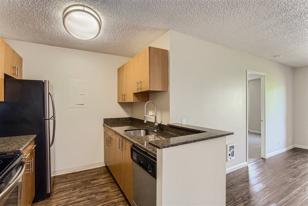 a kitchen with a sink and a refrigerator