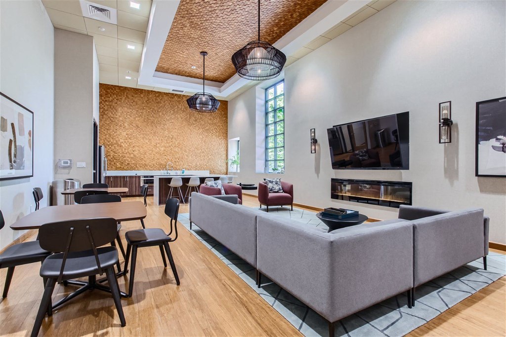 a living room with a couch table and chairs and a fireplace