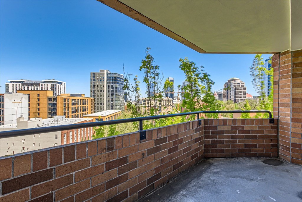 the view of the city from the balcony of an apartment building
