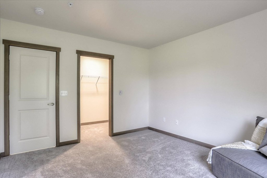 a living room with a couch and a door to a closet