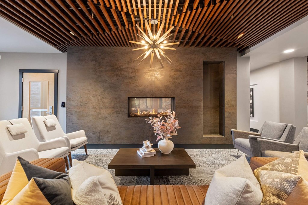 a living room with couches and chairs and a fireplace