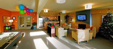 A living room with a pool table and a television.