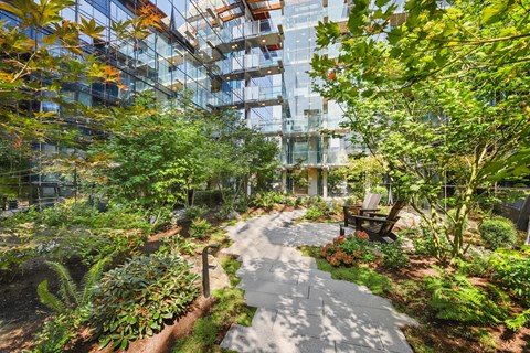 A garden with a winding walkway and a bench.