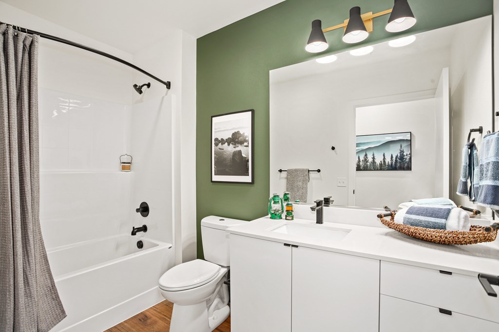 A bathroom with a white toilet and a white sink.